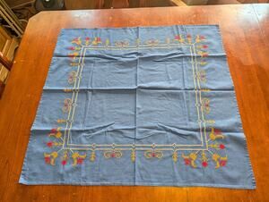 vintage hand-embroidered cotton-linen tablecloth features a charming floral Blue